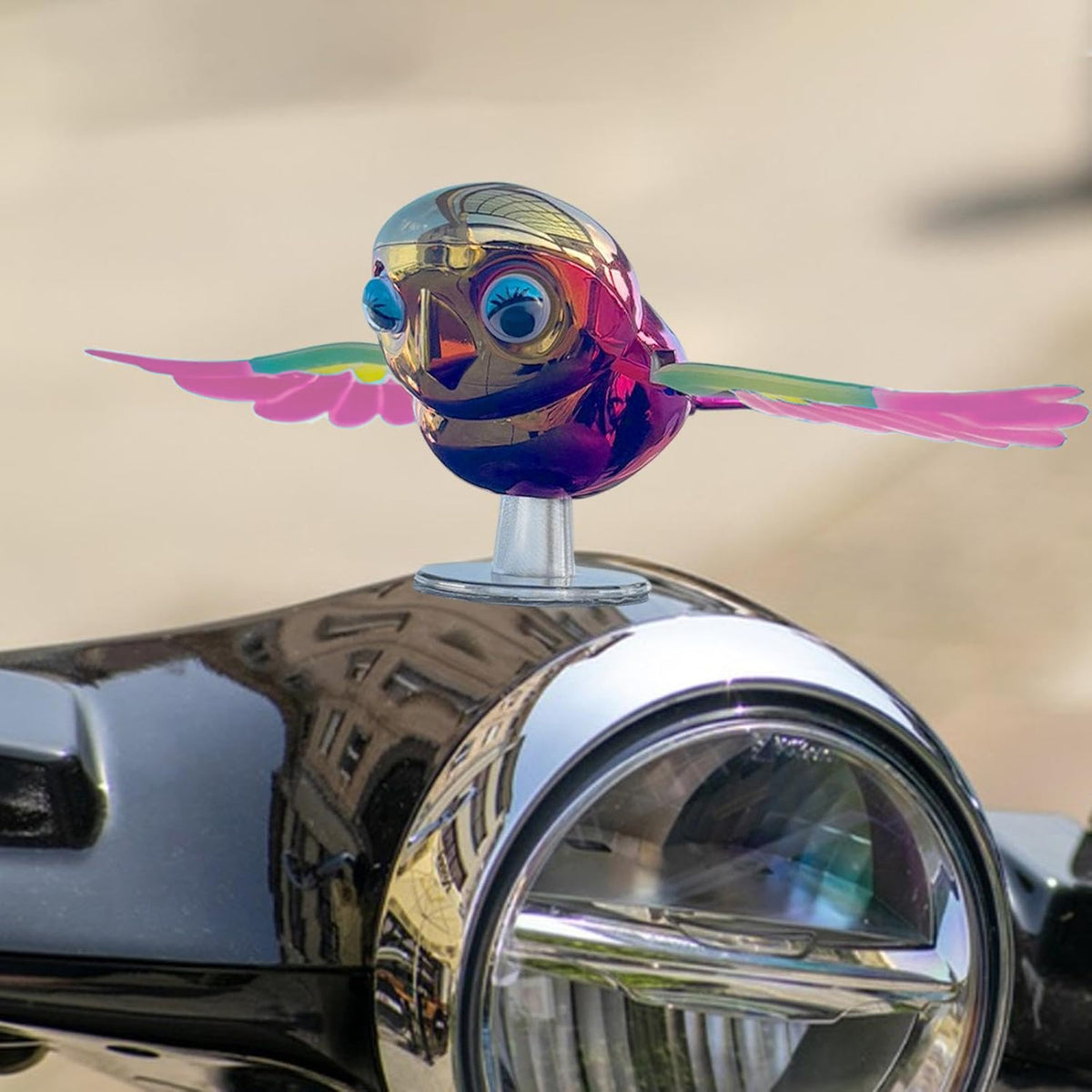 Colourful wind flying bird decoration on a car dashboard, view 4