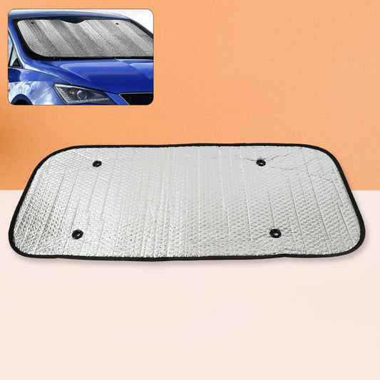 Foldable silver foil sun shade behind a car windshield