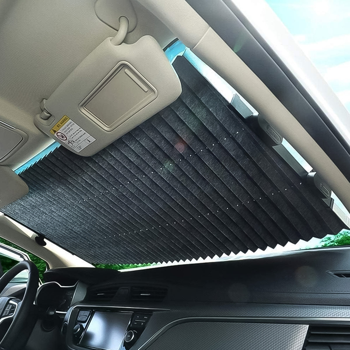 Retractable roller sun shade fixed across a car windshield with suction cups, view 5