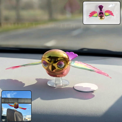 Colourful wind flying bird decoration on a car dashboard