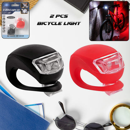 Two small silicone LED bicycle lights, front white and rear red