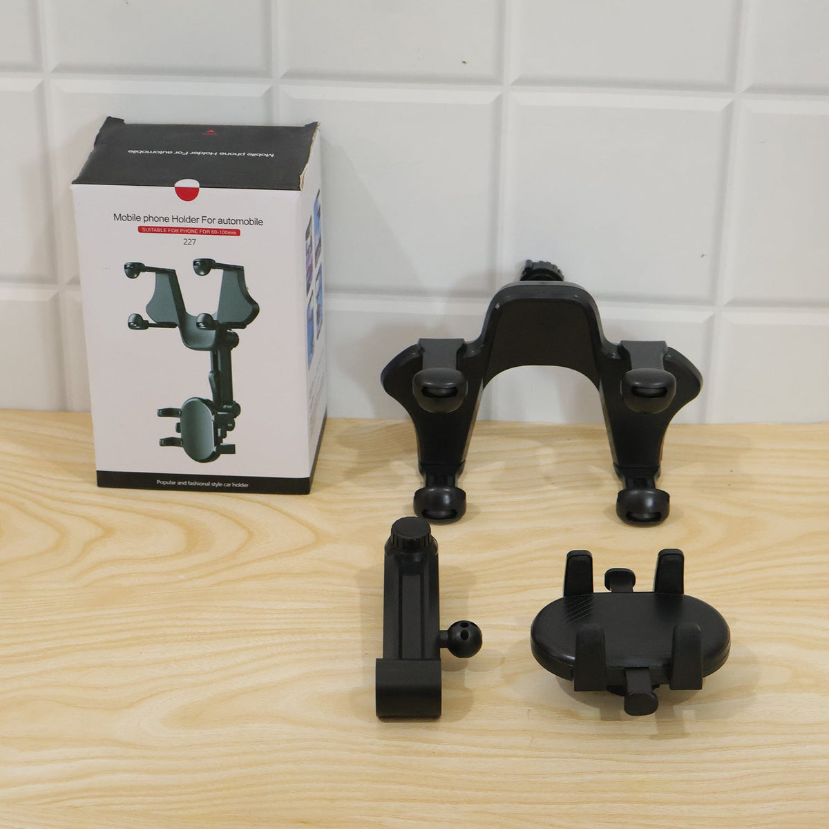 Car phone holder clamped to a rear view mirror holding a smartphone, view 6