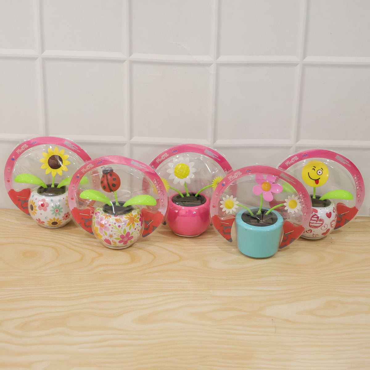 Solar dancing flower toy in a colourful pot on a car dashboard, view 6