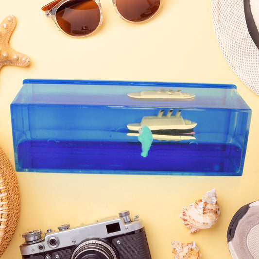 Clear acrylic ornament with a floating cruise ship and iceberg in blue liquid, view 2
