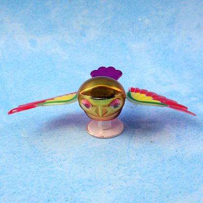 Colourful wind flying bird decoration on a car dashboard, view 6