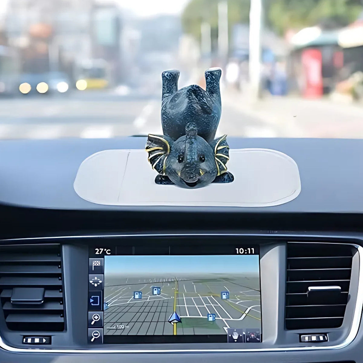 Large transparent silicone anti-slip mat on a car dashboard holding a phone, view 3