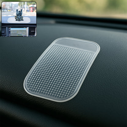 Large transparent silicone anti-slip mat on a car dashboard holding a phone