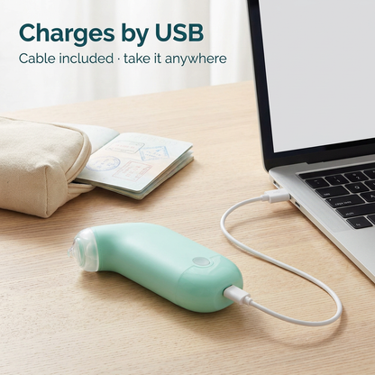 Pore cleaner charging by USB cable from a laptop, with travel pouch