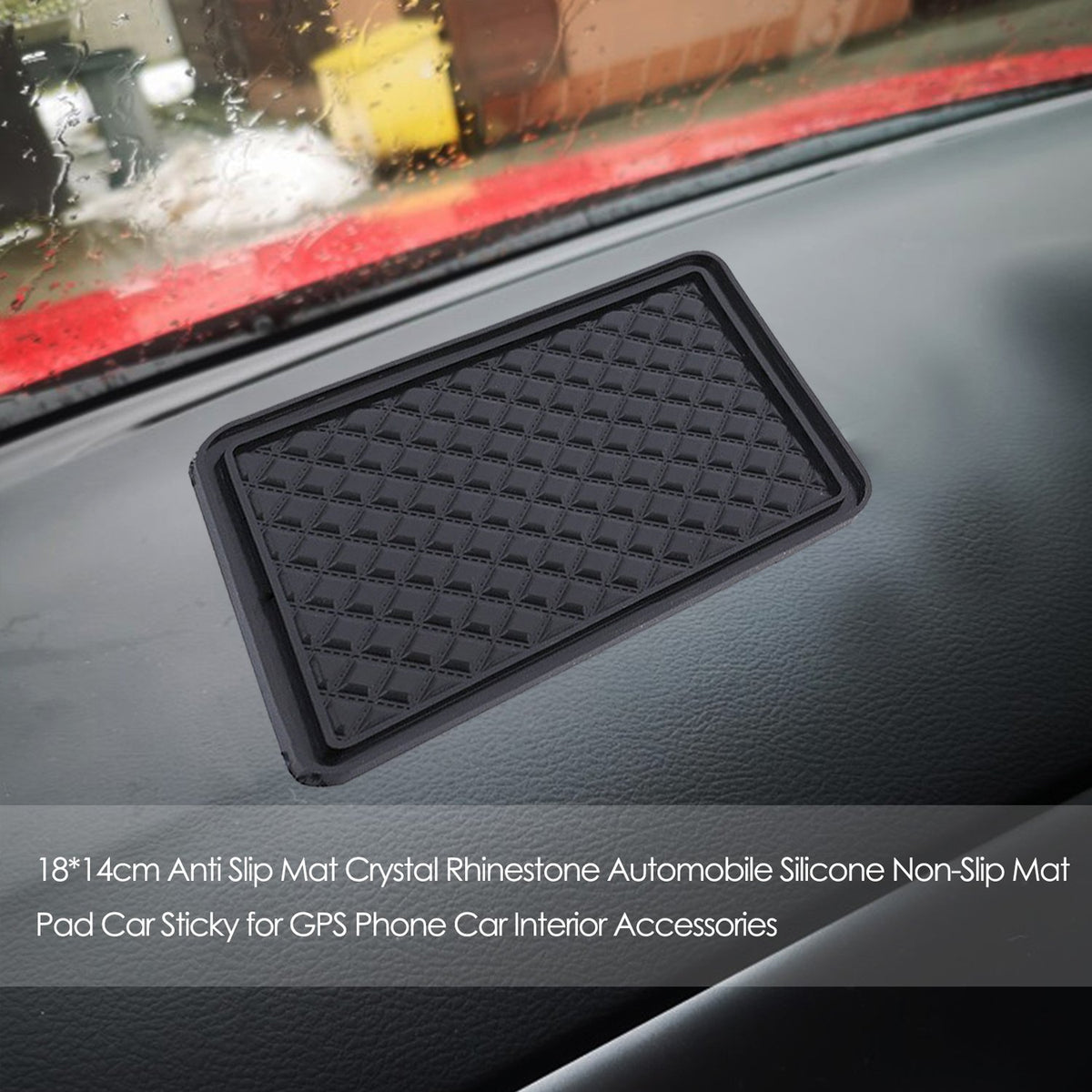Black anti-slip gel mat on a car dashboard holding a phone and keys