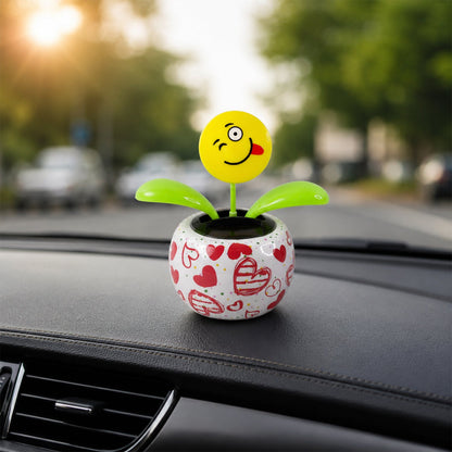 Solar dancing flower toy in a colourful pot on a car dashboard, view 5