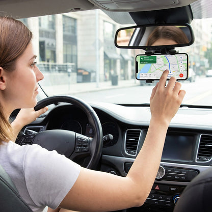 Car phone holder clamped to a rear view mirror holding a smartphone, view 3