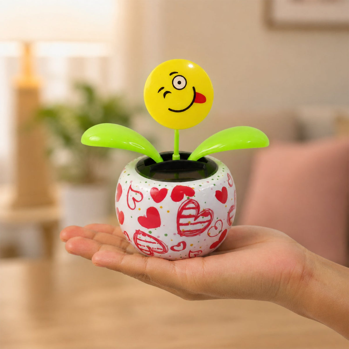 Solar dancing flower toy in a colourful pot on a car dashboard, view 4