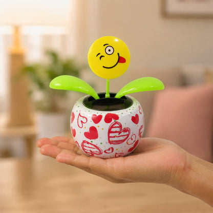 Solar dancing flower toy in a colourful pot on a car dashboard, view 4