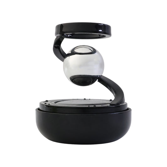 Solar rotating car air freshener with metallic spinning orb on dashboard