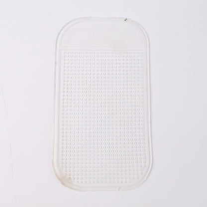 Large transparent silicone anti-slip mat on a car dashboard holding a phone, view 4