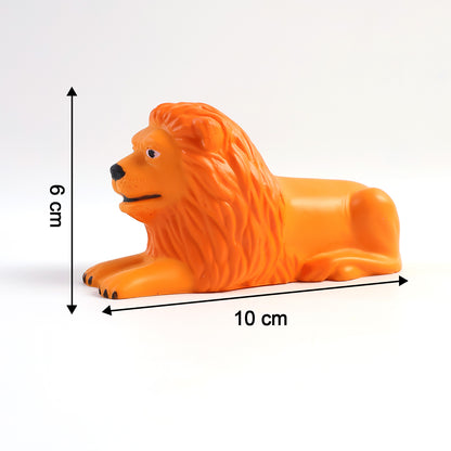 Golden orange lion figurine in a lying pose on a car dashboard, view 3