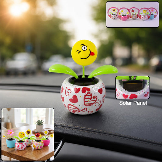 Solar dancing flower toy in a colourful pot on a car dashboard
