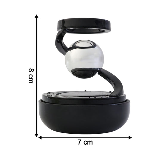 Solar rotating car air freshener with metallic spinning orb on dashboard, view 2