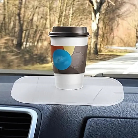 Large transparent silicone anti-slip mat on a car dashboard holding a phone, view 2