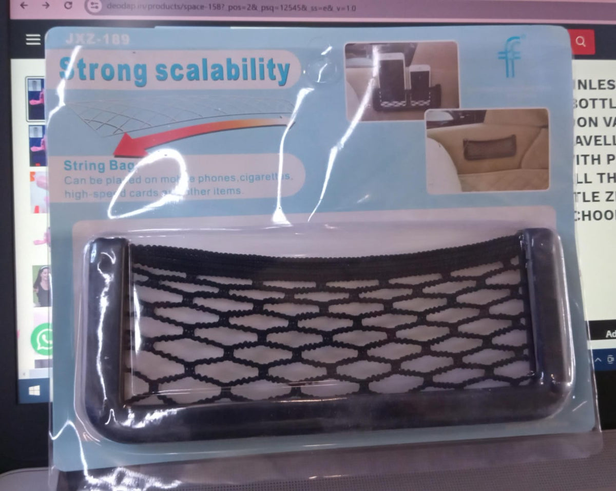 Stick-on mesh storage pocket holding a phone on a car seat side, view 3