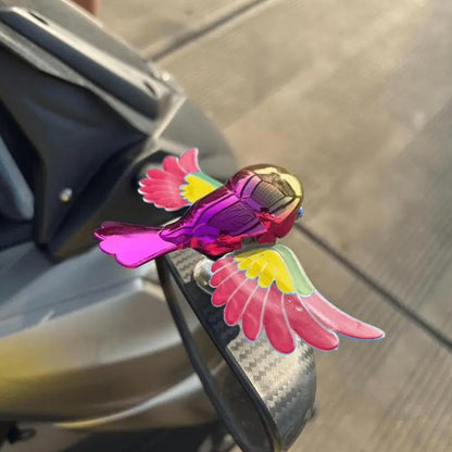 Colourful wind flying bird decoration on a car dashboard, view 3