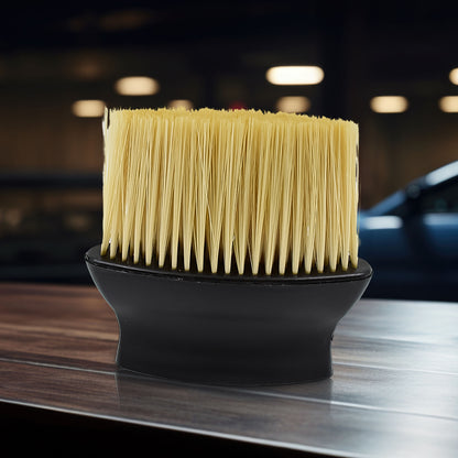 Soft long-bristle brush cleaning a car AC vent
