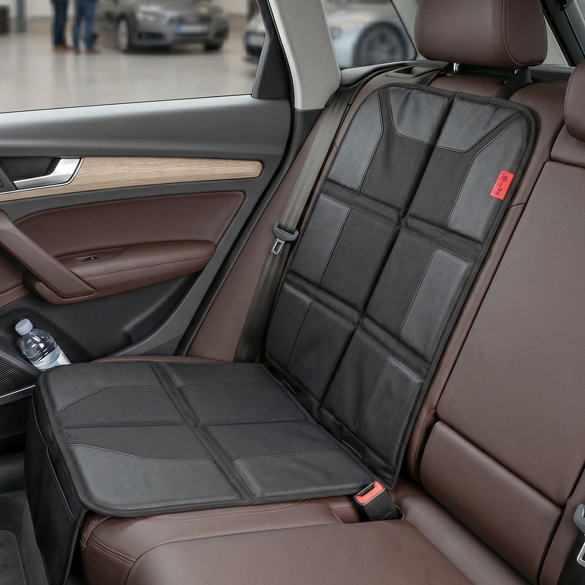 Black waterproof car seat protector mat under a child car seat, view 2